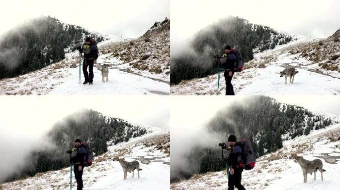 摄影师带着背包走在山脊上，上面覆盖着深雪