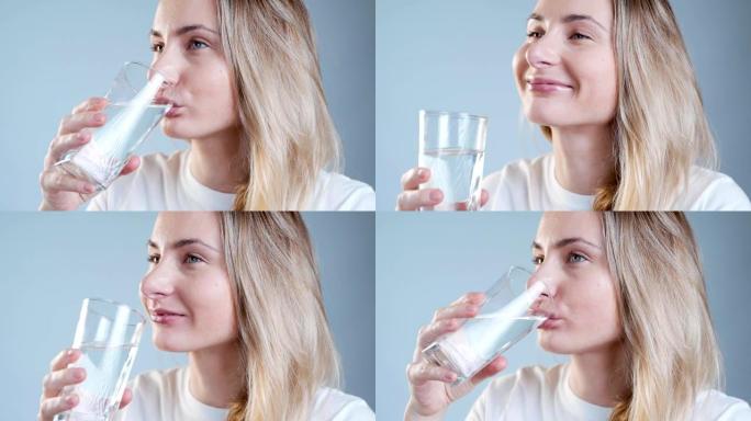 女人的饮用水。微笑的白人女模特拿着透明的玻璃在她的手。特写镜头