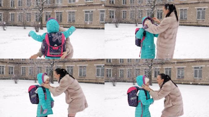 妈妈在冬天穿着皮大衣，放学后在学校大楼附近遇到了一个小女孩。