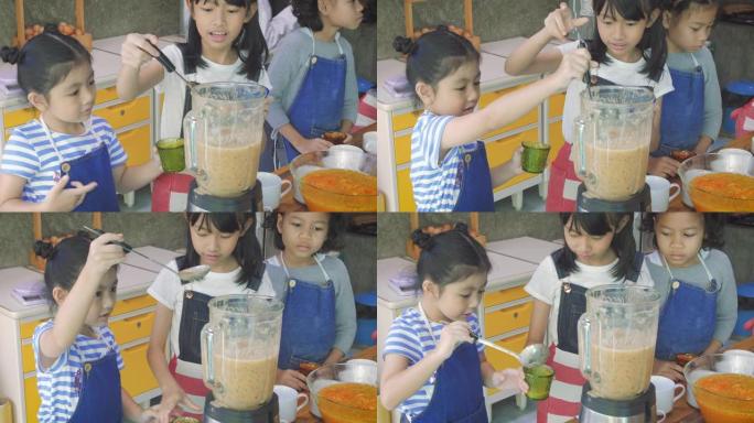 一群亚洲儿童在学校厨房为冰沙准备水果，学习和教育理念