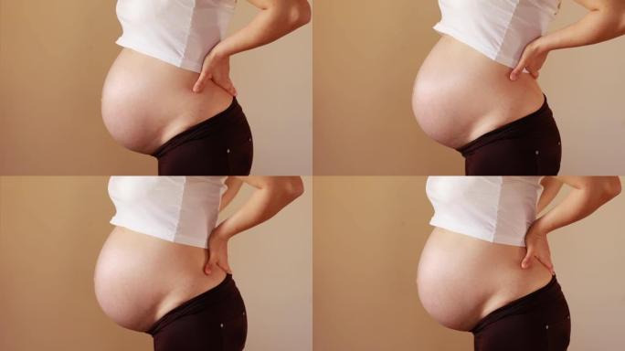 孕妇的下背部特写展示大肚子大肚婆