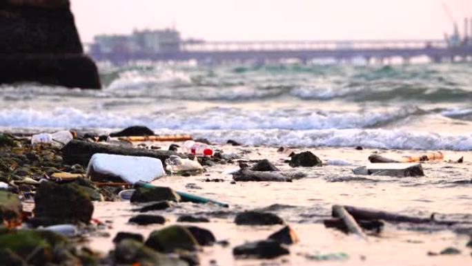 肮脏海滩上的垃圾，日落，石油钻探