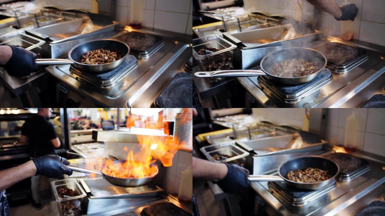 厨师在快餐店用油和燃烧的火炸肉