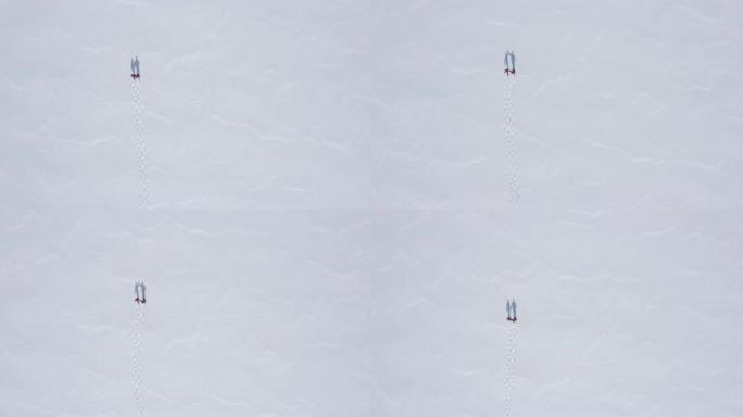 一对夫妇冬季在户外穿雪鞋的航拍视频