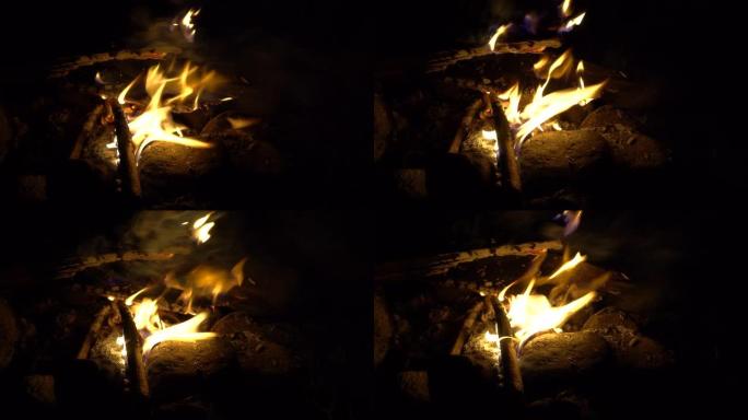4k镜头篝火燃烧树木在晚上。