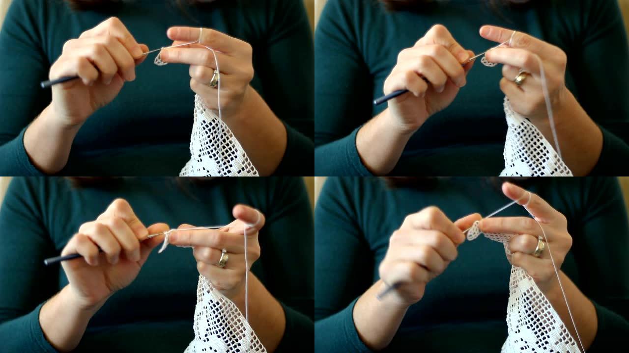 手工制作的传统针织。女人用缝纫针做帆布图案针。用螺纹覆盖