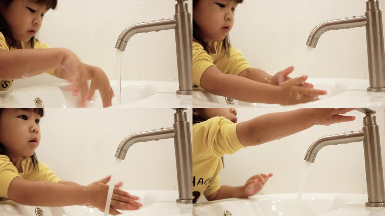 快乐的小女孩刷牙，在浴室用水清洁口腔。口腔卫生概念。