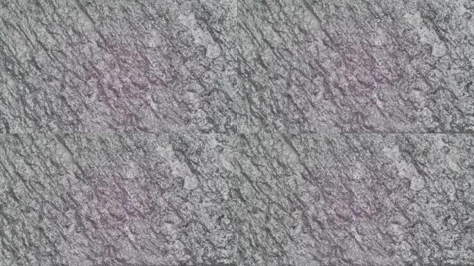 4k视频。石头复古的垃圾深灰色背景墙，用于背景或带有文字装饰的地方。缓慢移动