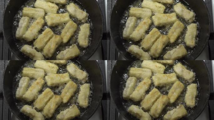 用食用油在铸铁煎锅中制作平底锅炸鳕鱼片