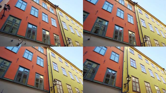 旧北方城市欧洲街道上的公寓楼。斯堪的纳维亚窗户。瑞典斯德哥尔摩狭窄街道上五颜六色的房屋外墙。旅行概念