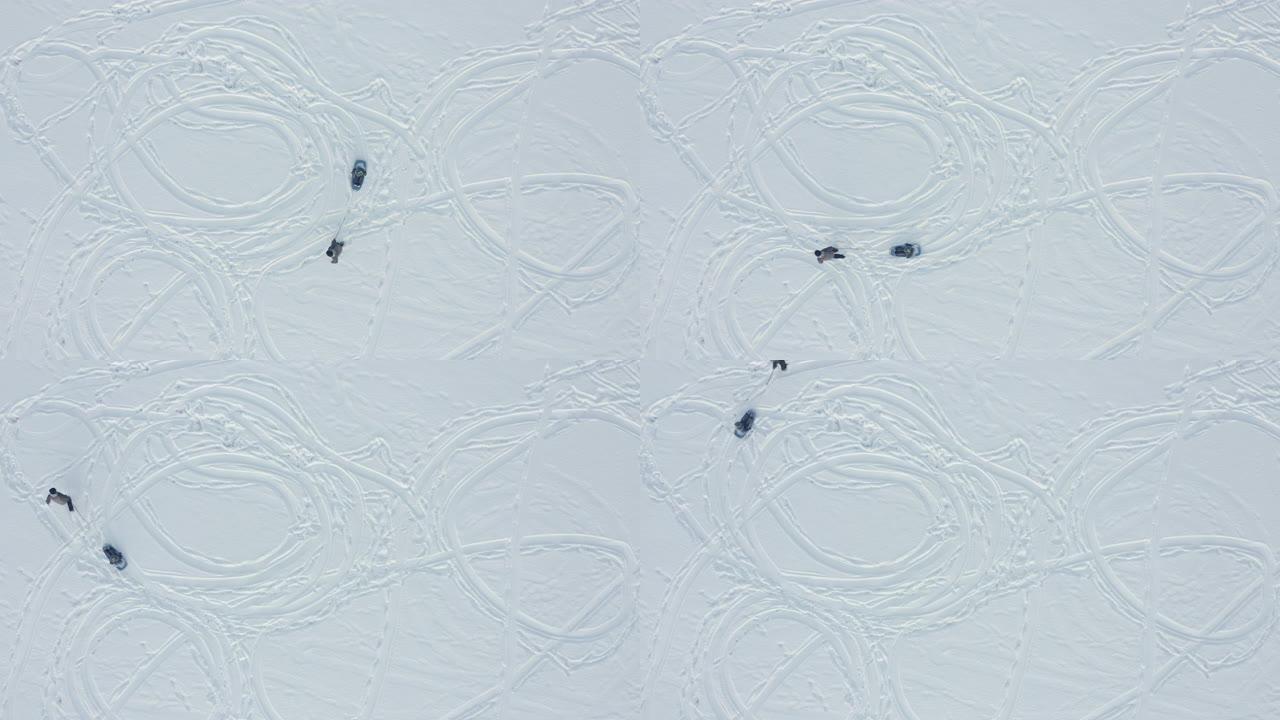 冬天在湖上拉雪橇的祖父的鸟瞰图