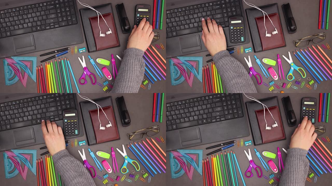女人在笔记本电脑键盘上打字，在工作空间办公桌上计算计算器 -- 停止运动