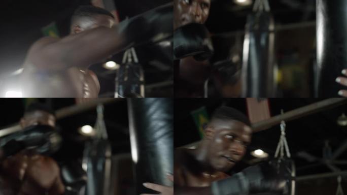 光着膀子的非洲裔美国男子在MMA体育馆里挥舞着年轻女子的沉重袋子