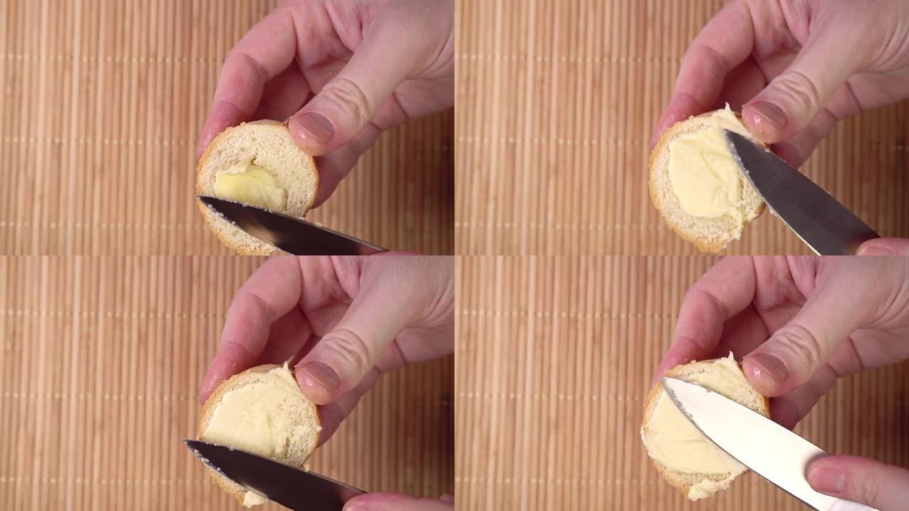 刀在面包上涂抹黄油特写