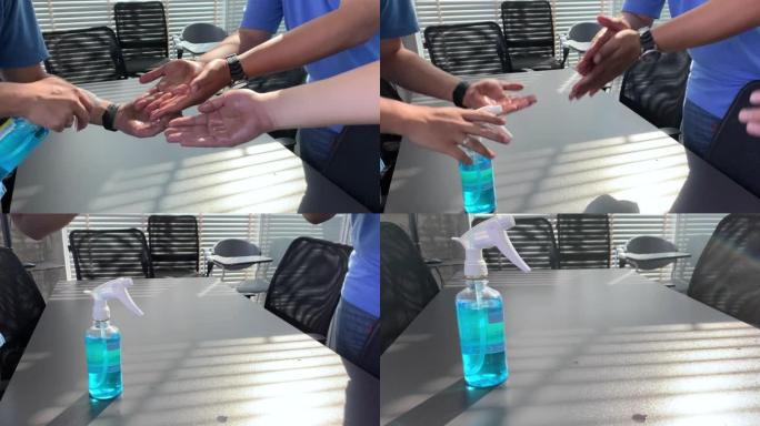 将酒精涂抹在清洁的手上，以保护新型冠状病毒肺炎病毒传播到办公室的员工