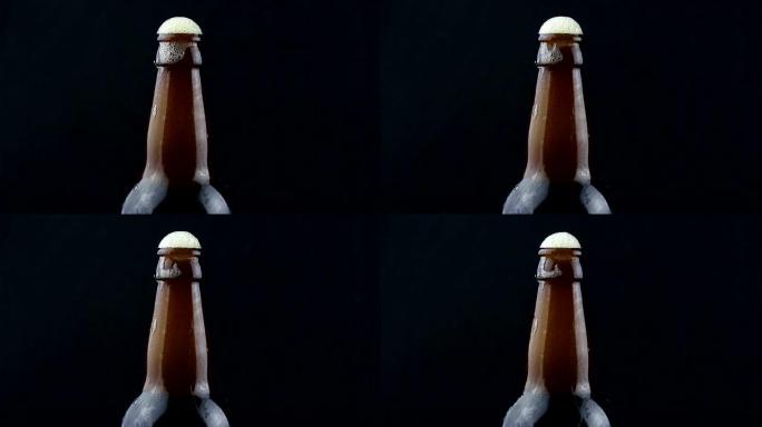啤酒泡沫从一瓶雾状的啤酒中流下。啤酒泡沫从一瓶黑啤酒中流下来。