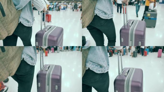 女子在机场候机楼提着旅行袋散步的场景