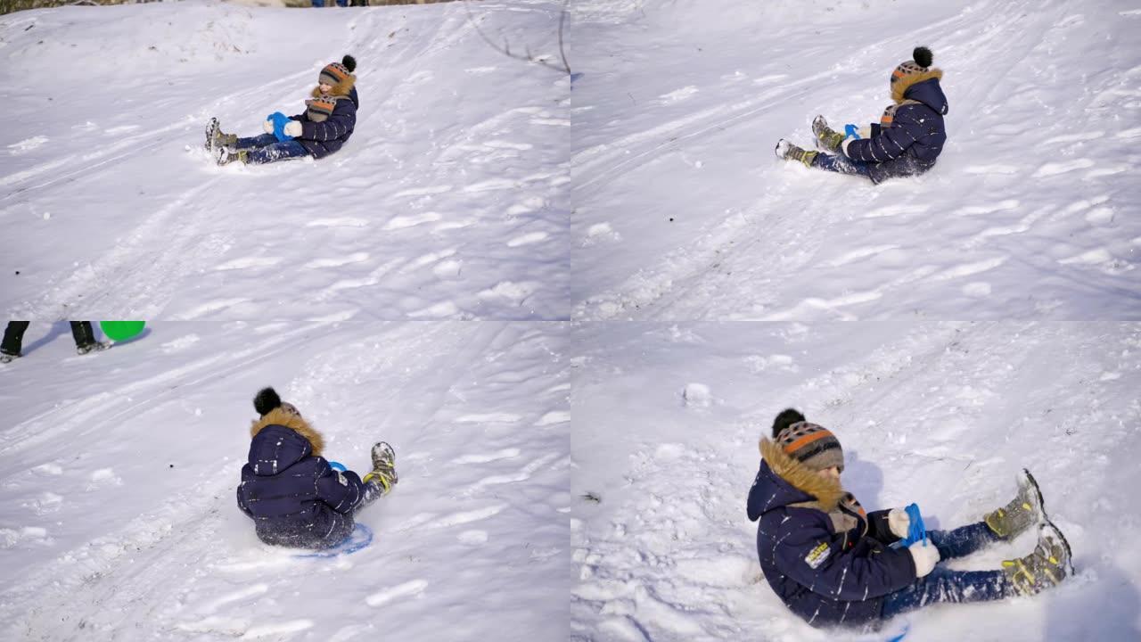 雪地滑梯上的男孩。