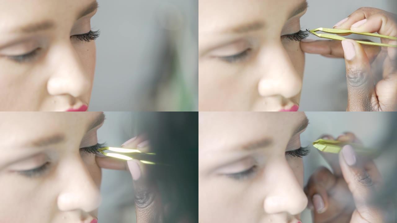 美容师的特写镜头仔细地将单个睫毛涂在模特的眼睛上