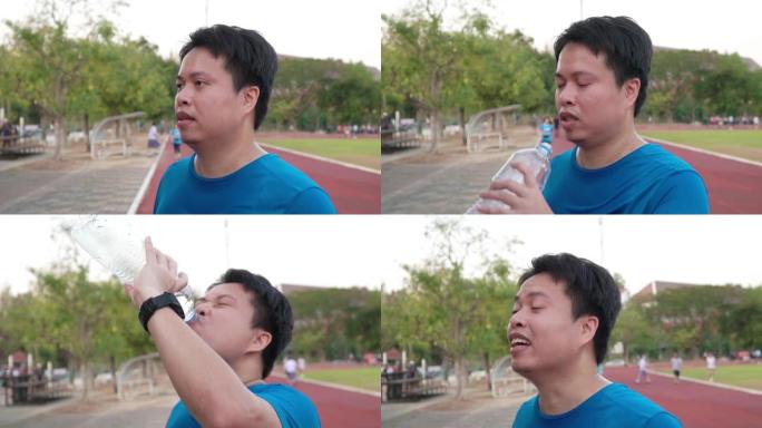 男子跑步后喝水。男子跑步后喝水