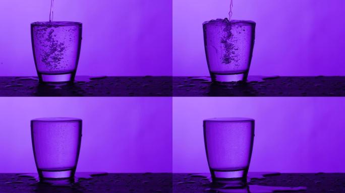 倒杯水-紫色背景玻璃杯水杯倒水