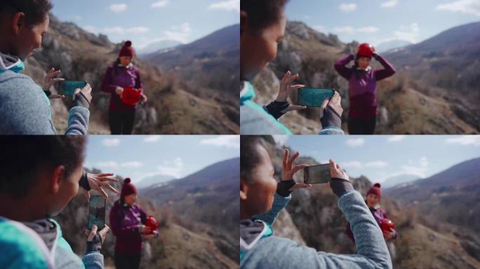 两名女性朋友准备攀岩并为社交媒体拍照
