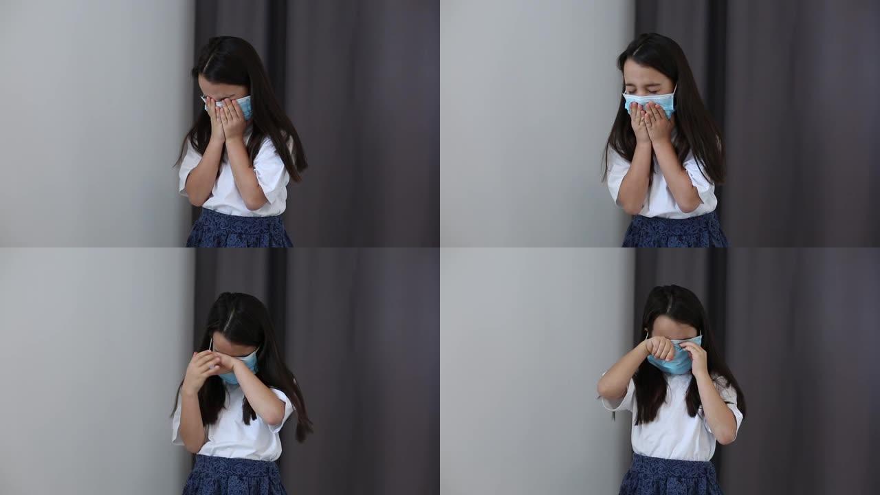 一个小女孩摘下了医用口罩。预防流行病