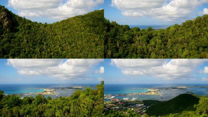 St Maartin空中v53低空飞过高大的山坡，可以看到跑道和机场的景色。