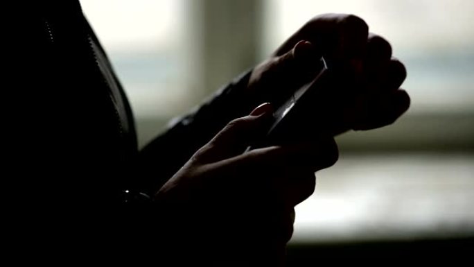 Close-up of the silhouette of female hands opening