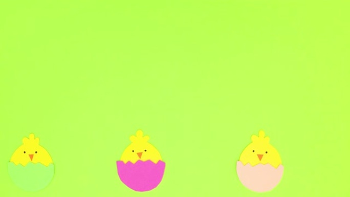 鸡蛋中的复活节鸡在绿色背景的底部交替移动-停止运动