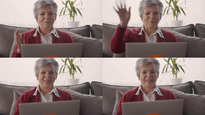 快乐的退休妇女使用现代技术与家人视频聊天