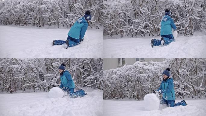 小男孩在冬天堆雪人