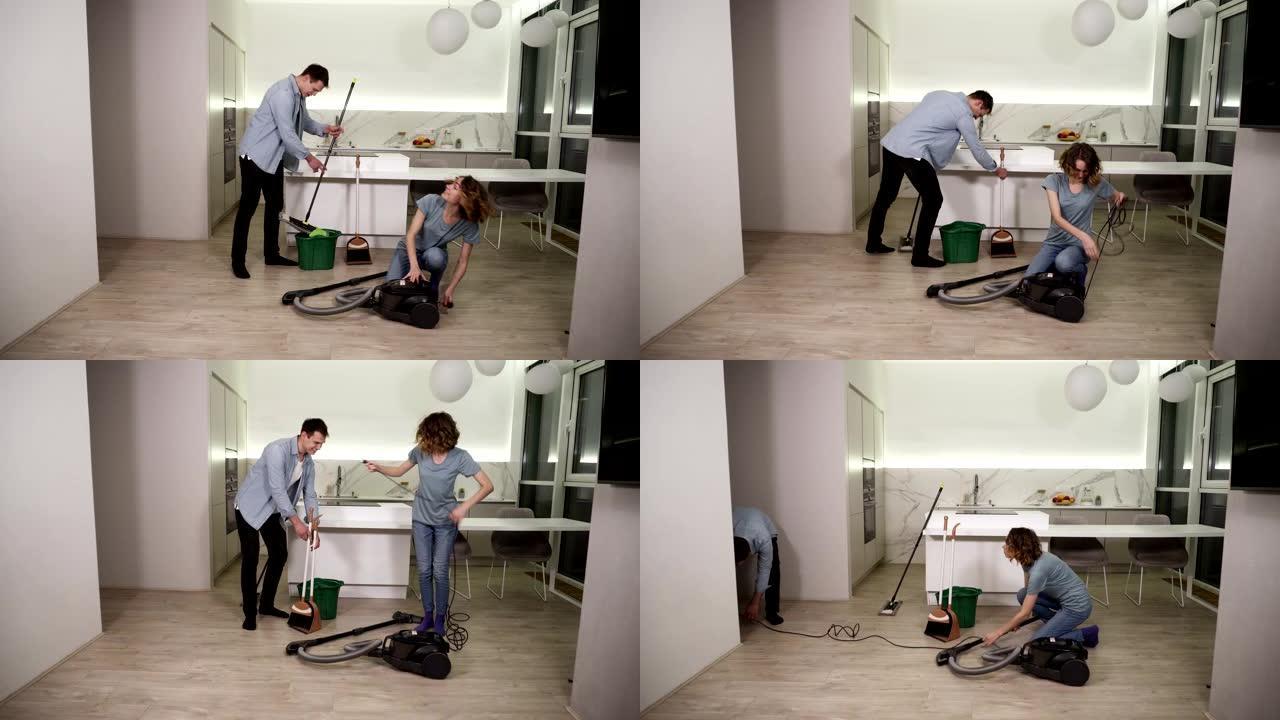 清洁日。年轻夫妇准备清洁公寓的工具-男人擦拭拖把，女孩准备吸尘器。要一起打扫工作室厨房