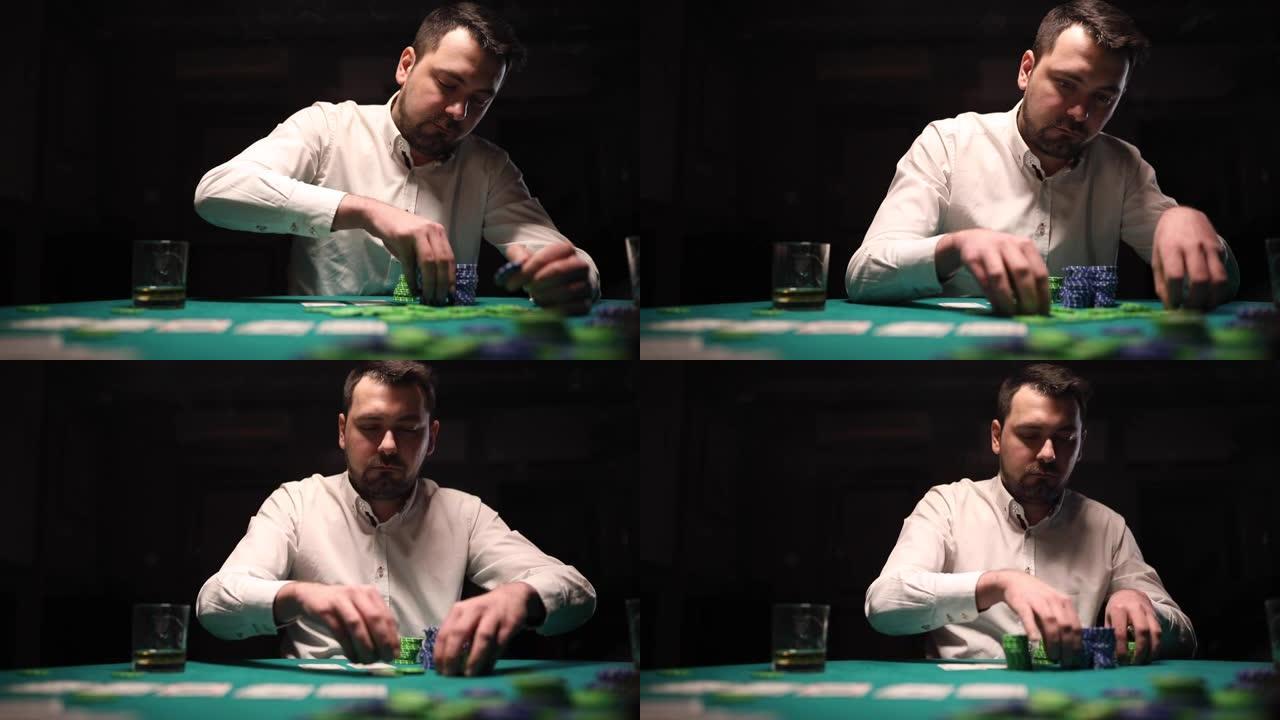 男子在暗室扑克游戏中堆积赌博筹码
