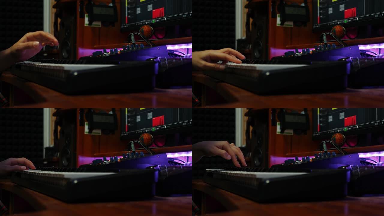女人手在家庭音乐工作室弹奏钢琴midi键盘。女手指在录音室弹钢琴。数字音频工作站，特写。音乐创作过程