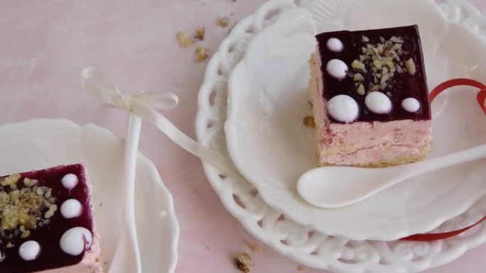 粉红色背景下美味的草莓蛋糕切片，奶油甜点，节日主题