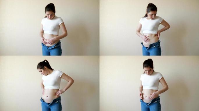 胖乎乎的女人触诊腹部和侧腹