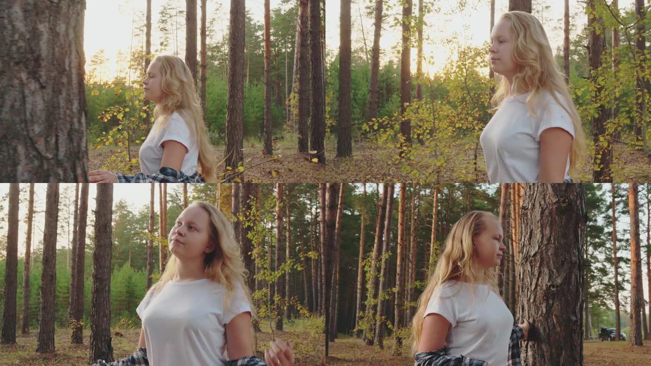 美丽的沉思女孩走在森林里，向一边看