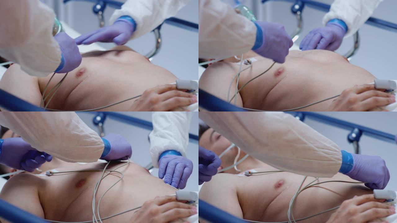 穿着防护服的医生将心电图引导到冠状病毒患者中注射