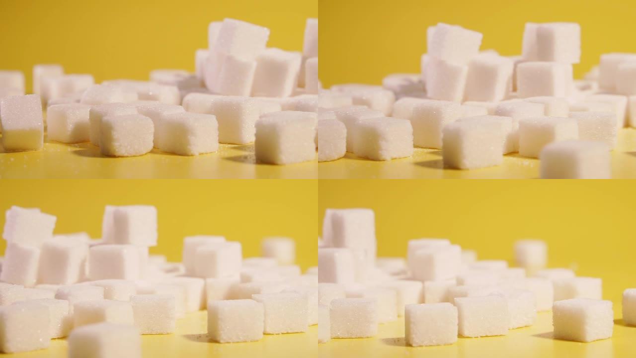 糖。方块中的糖位于黄色背景上。