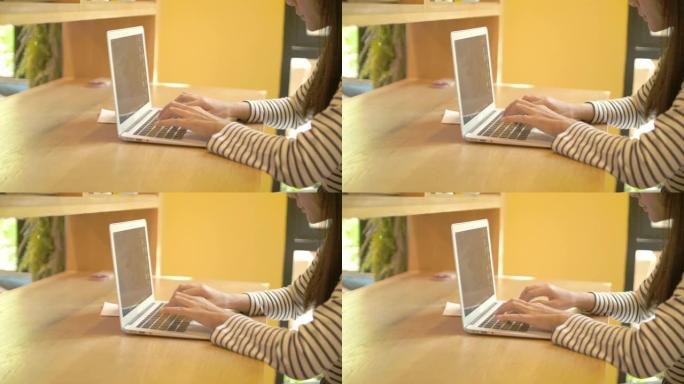 在咖啡馆里使用笔记本电脑的女人