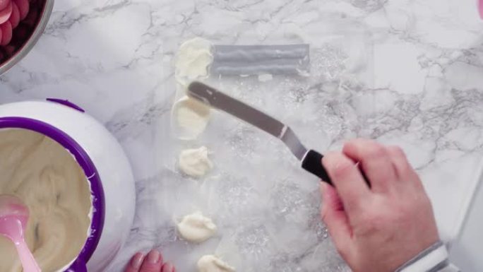 Pouring melted chocolate into a plastic chocolate 