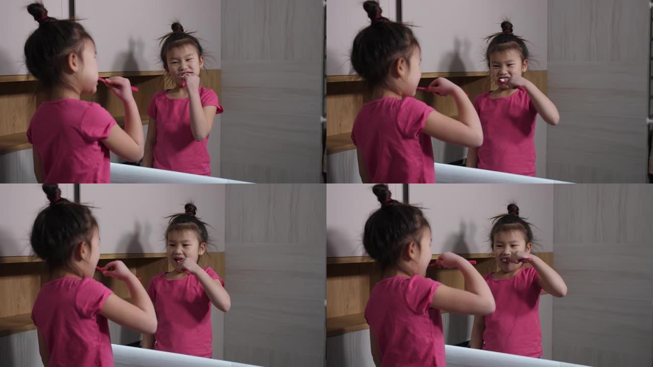 可爱的亚洲女孩在浴室镜子前刷牙