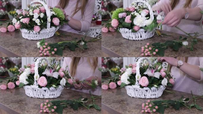 年轻女子花店在白色篮子里制作美丽的玫瑰花花束