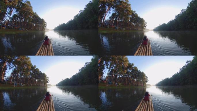 亚洲女子竹筏漂流与森林自然景观在早晨。旅游概念