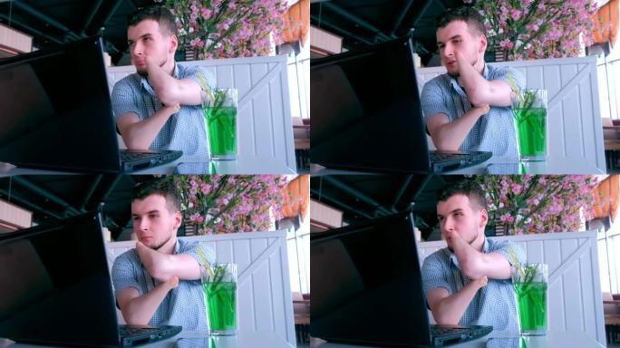 一个截肢的残疾人在咖啡馆用笔记本电脑视频聊天。