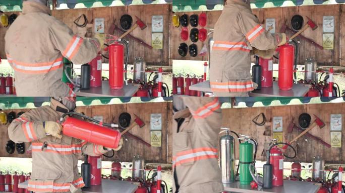 消防局的亚洲消防员手持灭火器准备执行任务。训练消防演习概念。慢动作