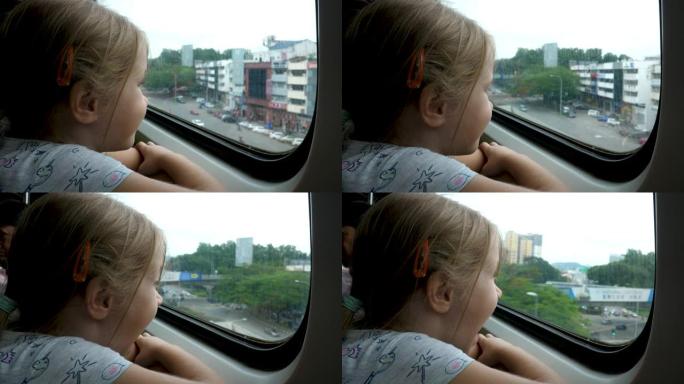 小女孩在旅途中向火车窗外望去
