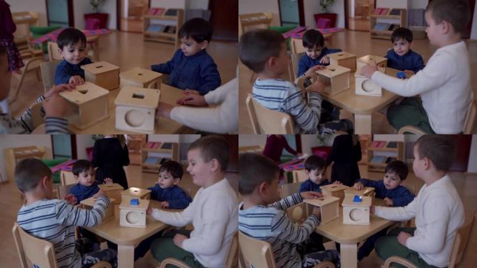 双胞胎男孩和他们的朋友在儿童保育教室里玩形状盒