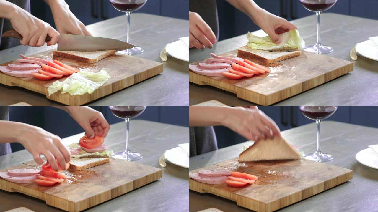 女人在厨房的木板上用刀将俱乐部三明治切成两半，在家做快餐，厨师正在煮三明治。特写。女孩的手切面包做三